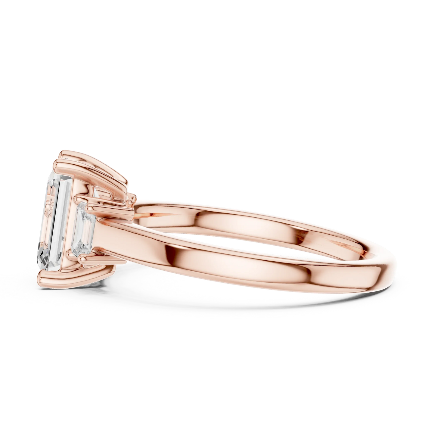 Side view of rose gold emerald cut three stone diamond ring, highlighting design profile.