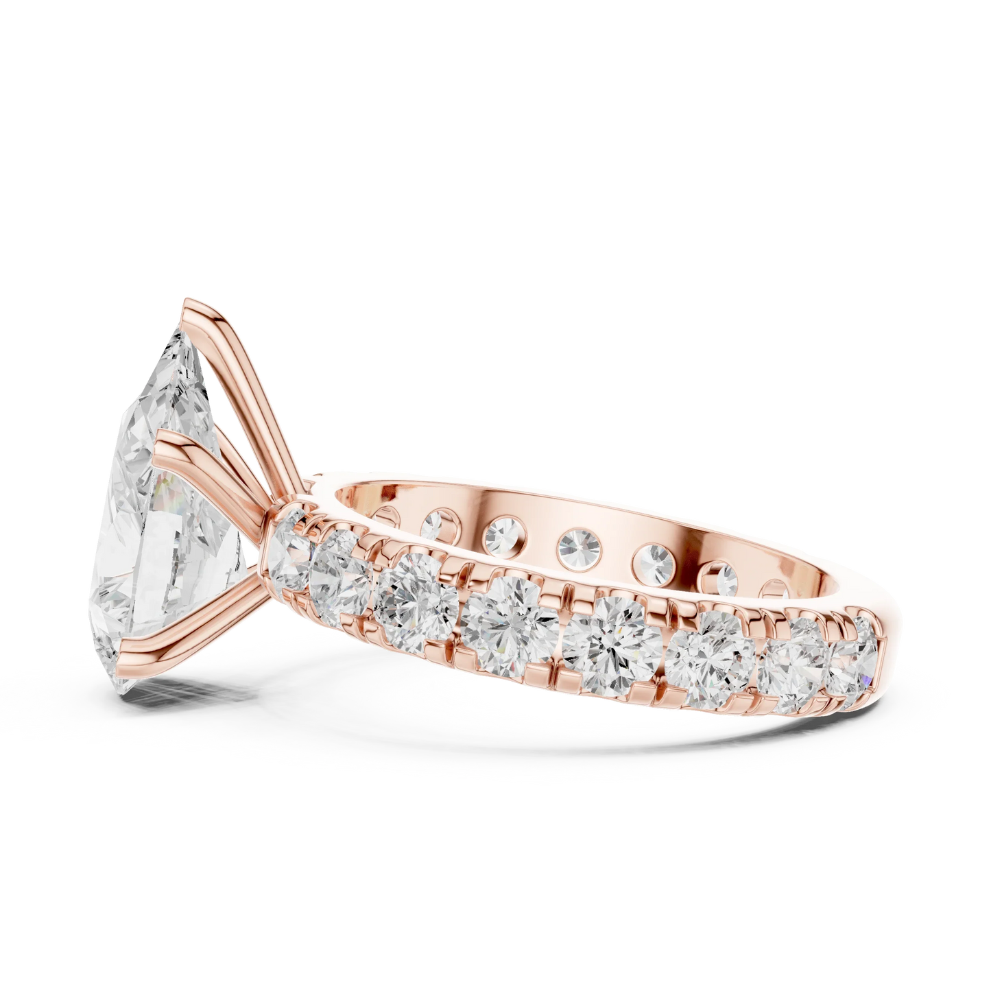 Side view of rose gold pear cut solitaire ring highlighting pave band and prong setting