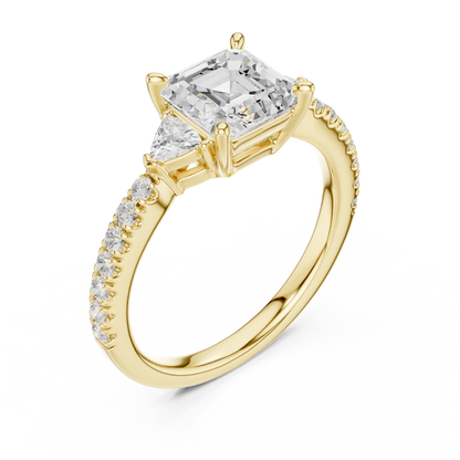 Front view of yellow gold Asscher three stone diamond pave ring, emphasizing geometric cut and brilliance.