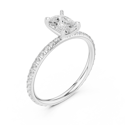 Front view of white gold cushion cut solitaire ring with thin pavé diamond band and center stone