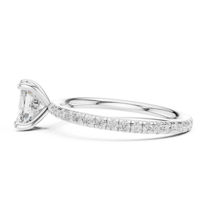 Side view of white gold cushion cut solitaire ring with thin pavé diamond band and raised setting