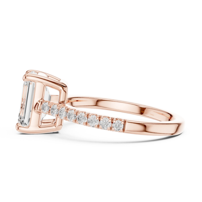 Side profile of rose gold emerald-cut diamond pavé band ring with detailed band setting