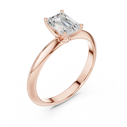 Front view of rose gold emerald diamond solitaire ring, showcasing gemstone brilliance.