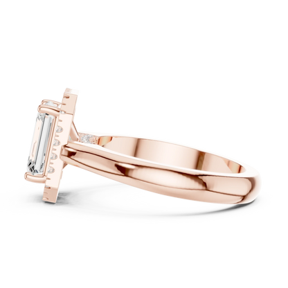 Side view of rose gold emerald halo ring highlighting diamond setting and band profile