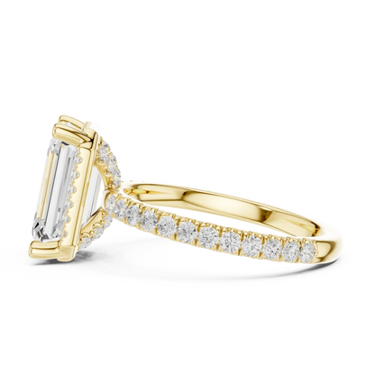 Side view of yellow gold emerald cut solitaire ring highlighting hidden halo and thin pav茅 band design