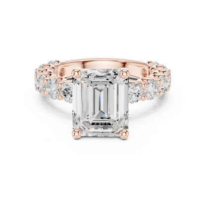 Lab-grown emerald cut solitaire ring in rose gold with shared prong large stone band