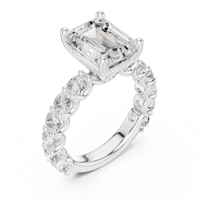 Front view of white gold emerald cut solitaire ring with shared prong large stone band and center stone