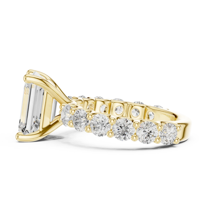 Side view of yellow gold emerald cut solitaire ring with shared prong large stone band and prong setting