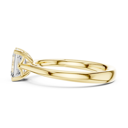 Side profile of yellow gold emerald solitaire ring with lab-grown emerald highlighting elegant structure