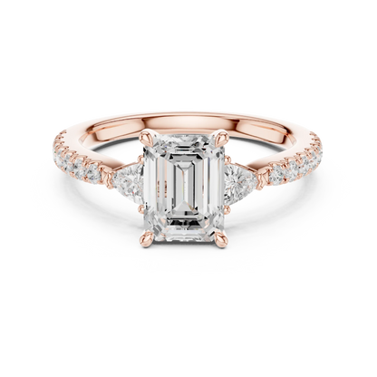 Lab-grown emerald cut three stone diamond pave ring in rose gold, soft tone top view.