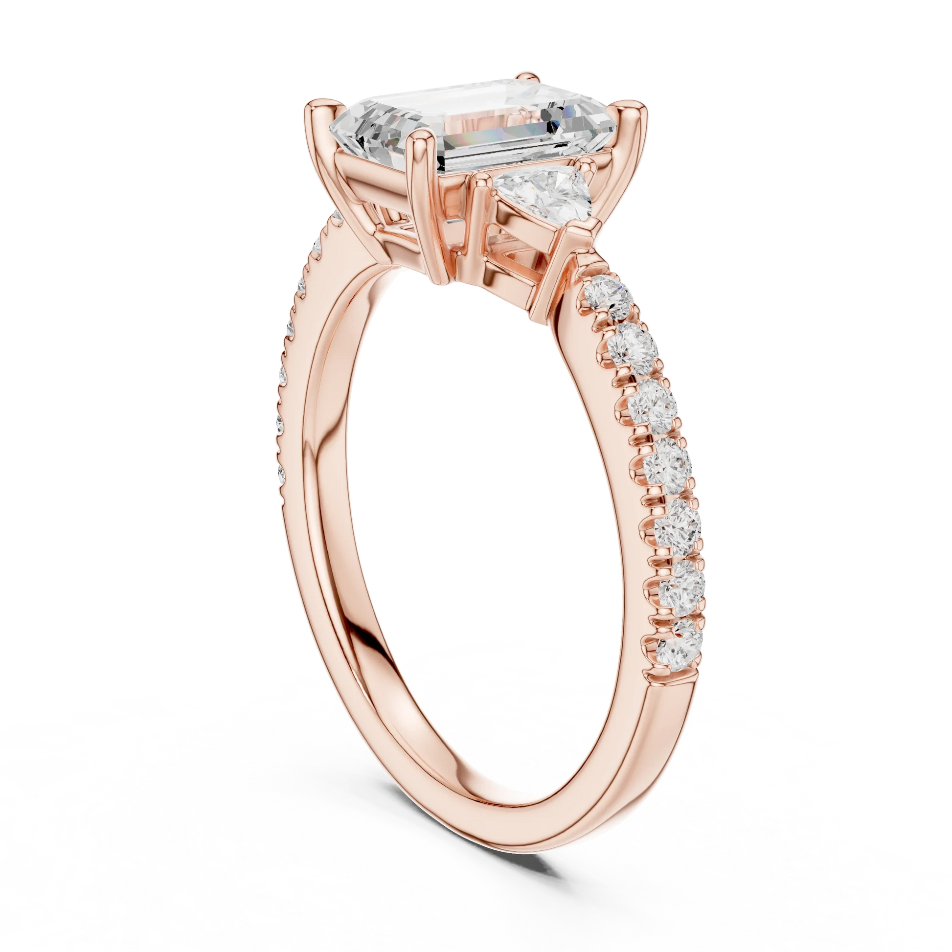 Back side view of rose gold emerald three stone diamond pave ring, detailing band and setting.