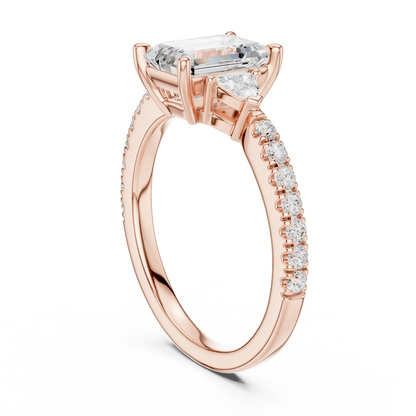 Back side view of rose gold emerald three stone diamond pave ring, detailing band and setting.