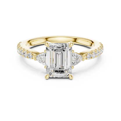Lab-grown emerald cut three stone diamond pave ring in yellow gold, classic top view.