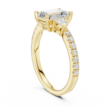 Back side view of yellow gold emerald three stone diamond pave ring, showing band structure.