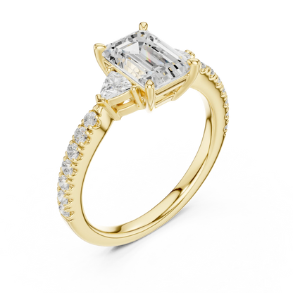 Front view of yellow gold emerald three stone diamond pave ring, emphasizing brilliance.