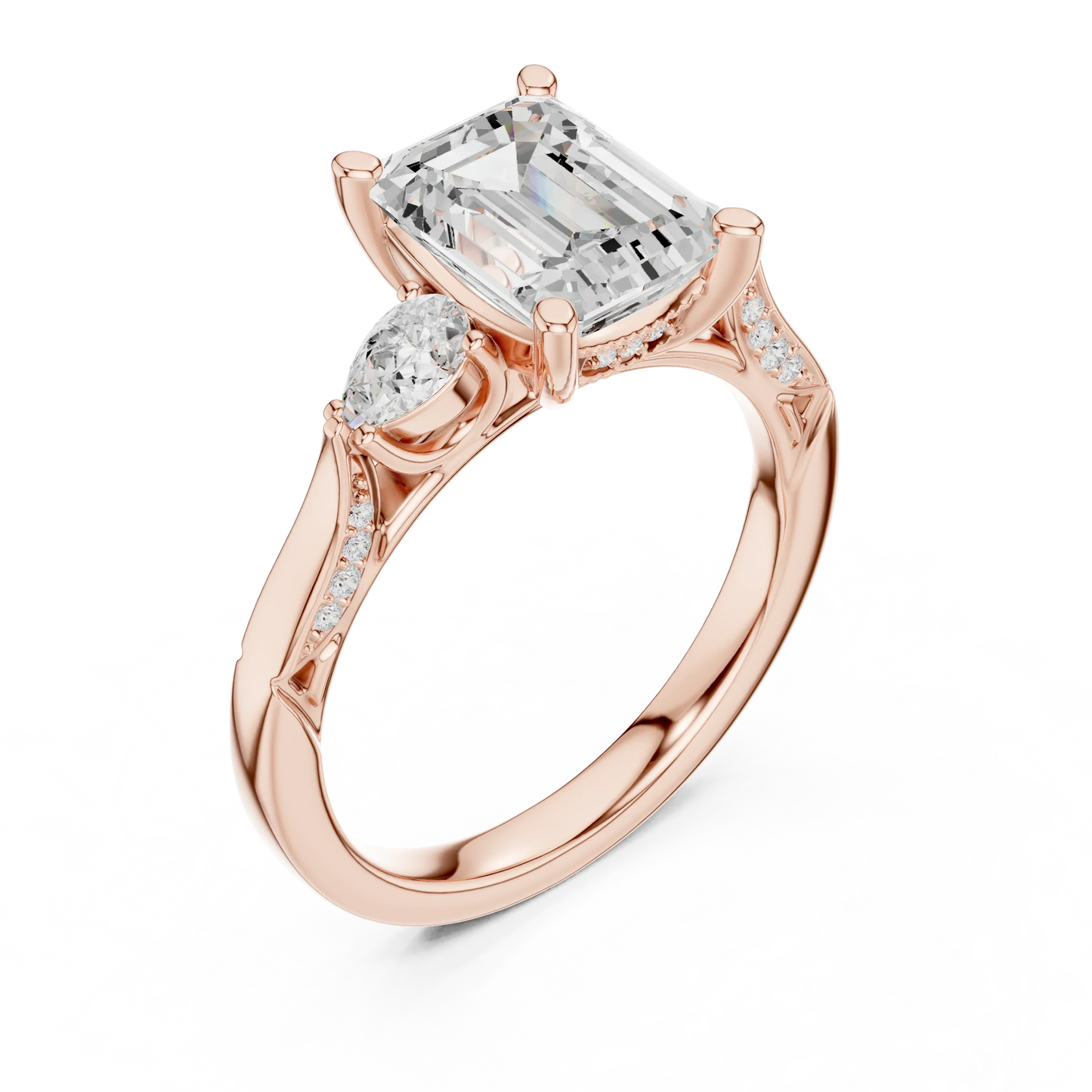 Front view of rose gold emerald three stone ring with pear side stones, accent band and lab-grown diamonds 鈥?Australia