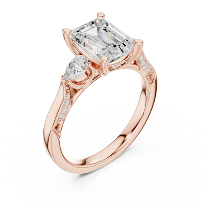 Front view of rose gold emerald three stone ring with pear side stones, accent band and lab-grown diamonds 鈥?Australia