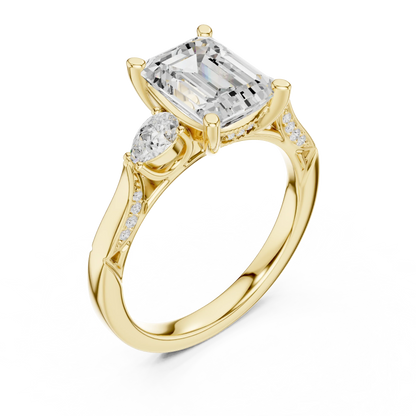 Front view of yellow gold emerald three stone ring with pear side stones, accent band and lab-grown diamonds 鈥?Australia