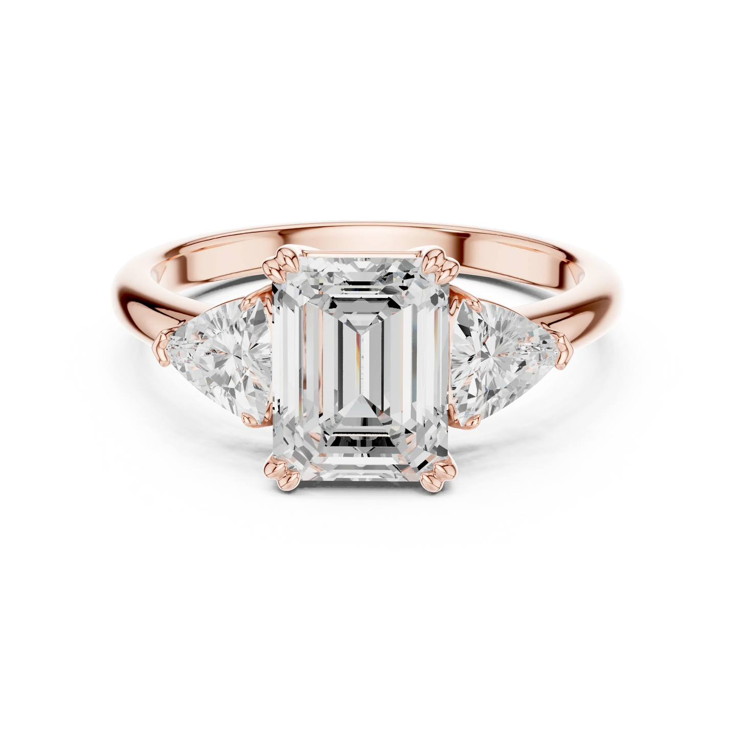 Emerald three-stone ring in rose gold with trillion cut side stones and lab-grown diamond 鈥?Australia