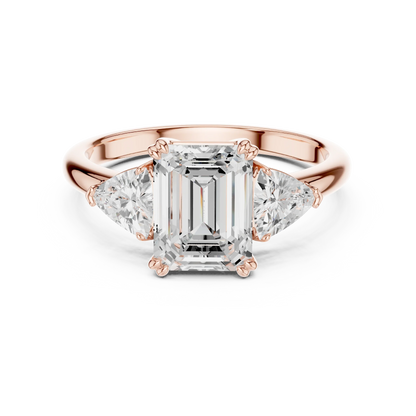 Emerald three-stone ring in rose gold with trillion cut side stones and lab-grown diamond 鈥?Australia