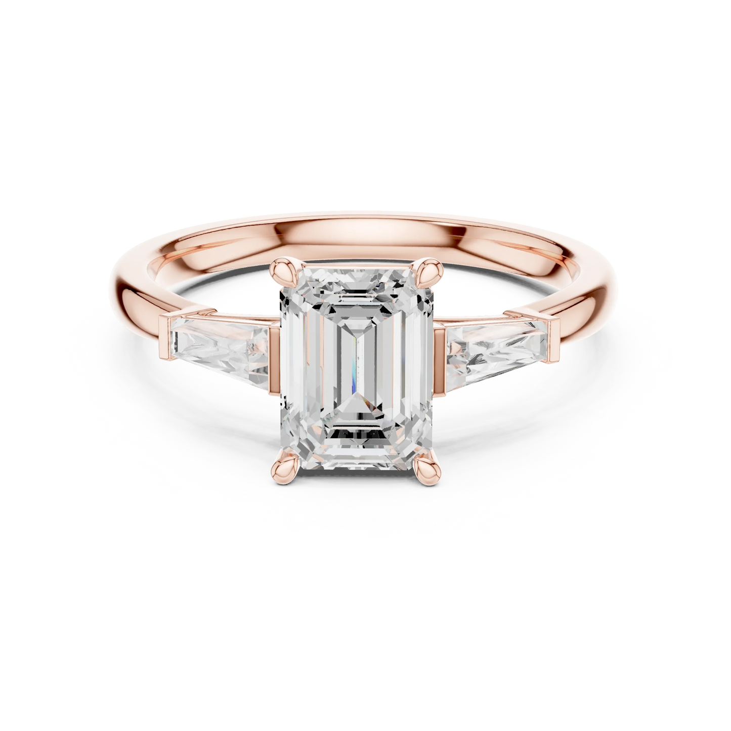 Rose gold emerald three-stone ring with tapered baguette side stones