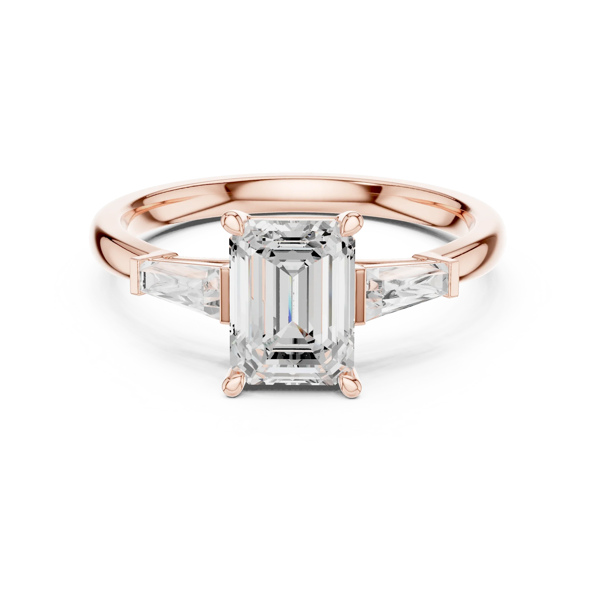 Rose gold emerald three-stone ring with tapered baguette side stones