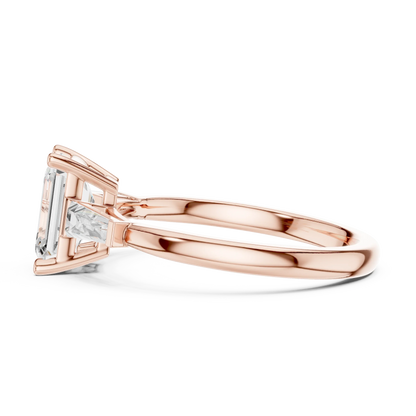 Rose gold emerald three-stone side view ring with tapered baguette side stones