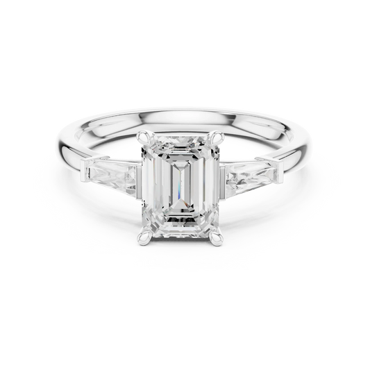 White gold emerald three-stone ring with tapered baguette side stones