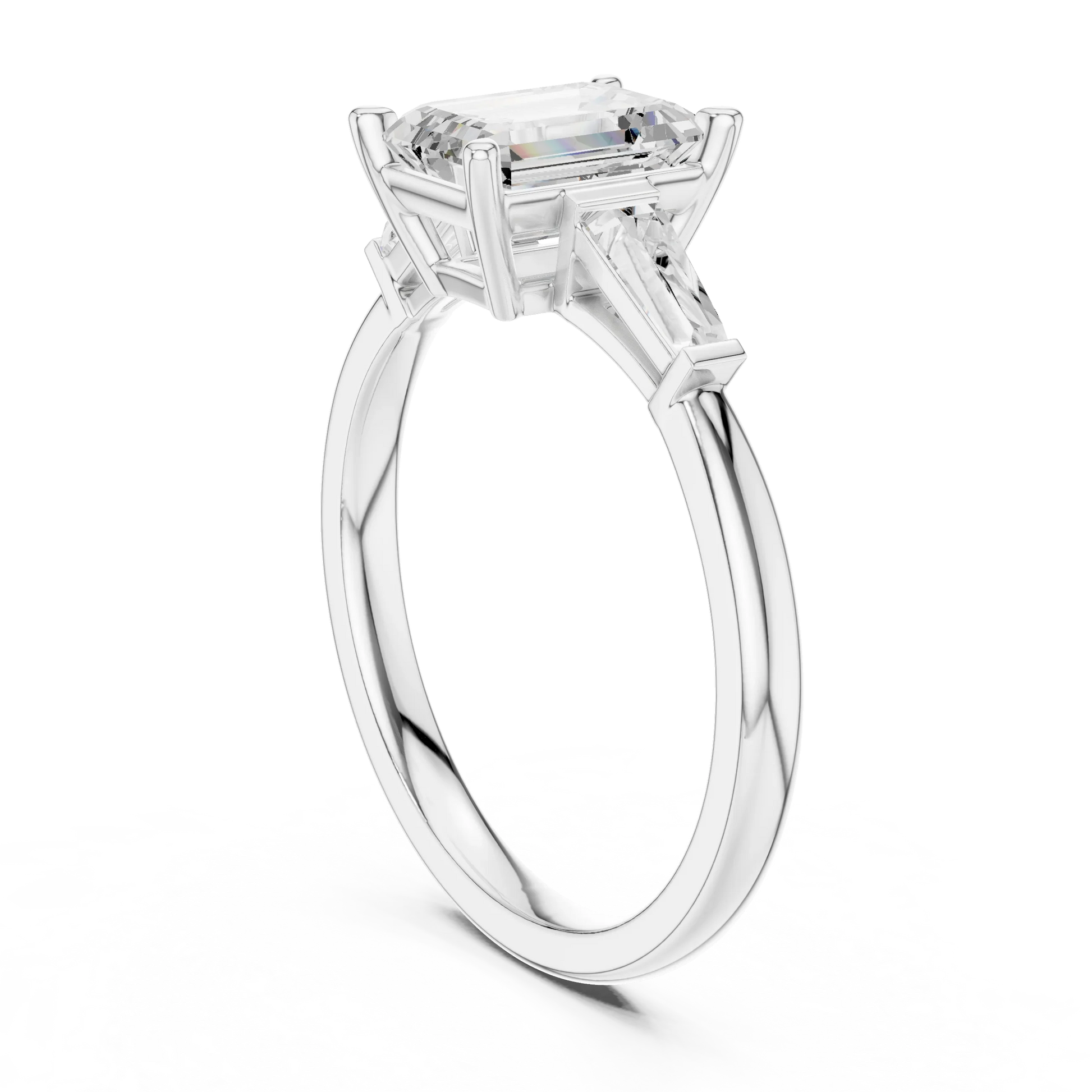 White gold emerald three-stone ring with tapered baguette side stones Top view