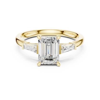 Yellow gold emerald three-stone ring with tapered baguette side stones
