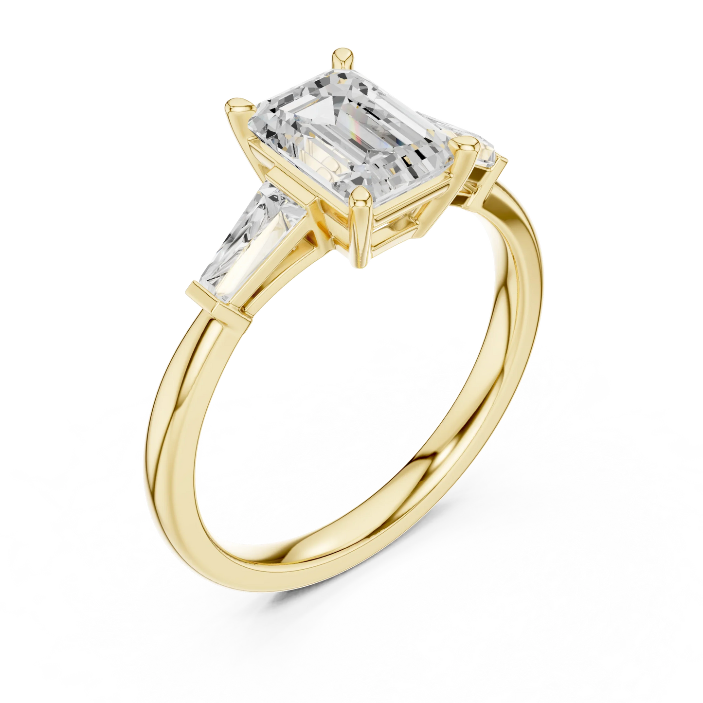 Yellow gold emerald three-stone ring with tapered baguette side stones front view