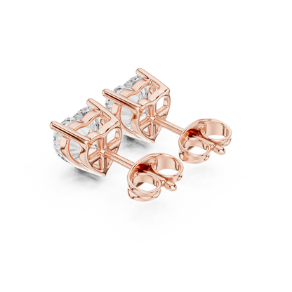 Rose gold earrings with clear gemstones on a white background