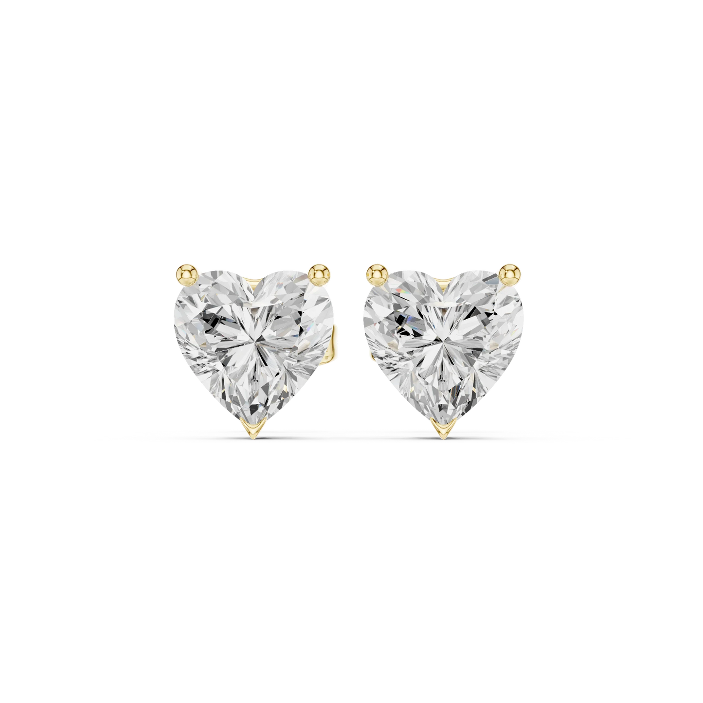 Heart-shaped diamond earrings on a white background in yellow gold