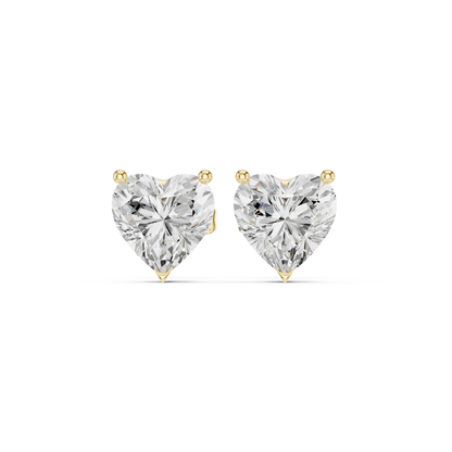 Heart-shaped diamond earrings on a white background in yellow gold