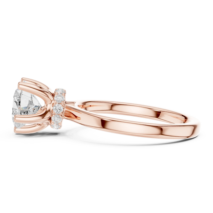 Side view of rose gold heart cut solitaire ring highlighting hidden halo and domed band design