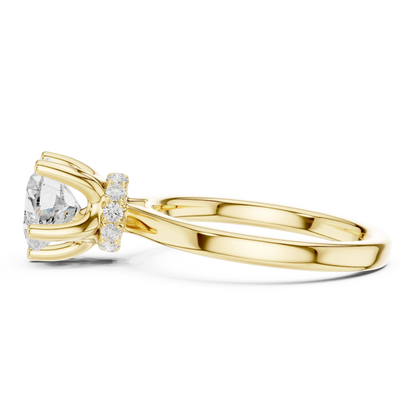 Side view of yellow gold heart cut solitaire ring highlighting hidden halo and domed band design