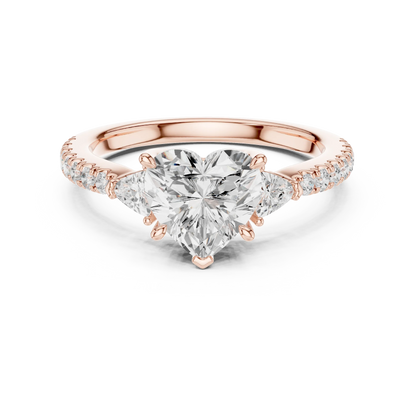 Lab-grown heart shape three stone diamond ring with half moon side stones and pave band in rose gold, top view.