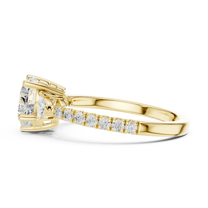 Side view of yellow gold heart shape three stone diamond ring with half moon side stones and pave band, highlighting design profile.