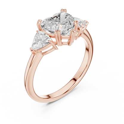 Front view of rose gold heart three-stone ring with trillion cut side stones and lab-grown diamond 鈥?Australia