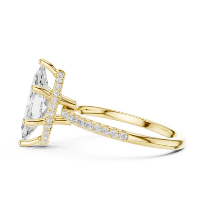 Side view of yellow gold marquise cut solitaire ring highlighting thin pave band and gemstone setting