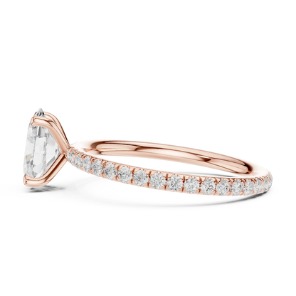 Side profile of rose gold oval cut solitaire ring with thin pavé diamond band and elevated center stone