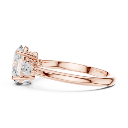 Side view of rose gold oval three-stone ring with pear side stones and lab-grown diamond 鈥?Australia