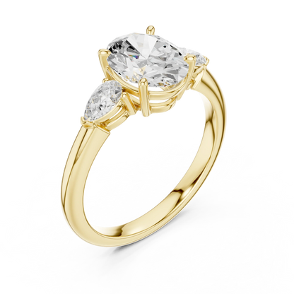 Front view of yellow gold oval three-stone ring with pear side stones and lab-grown diamond 鈥?Australia