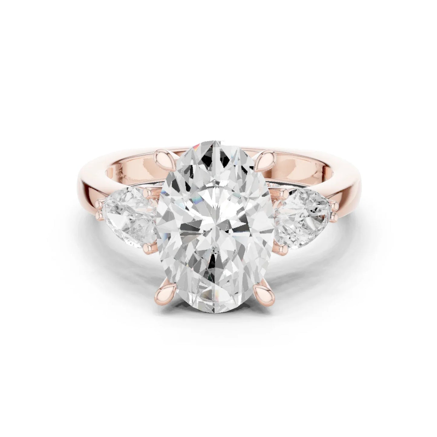 Oval three stone ring with pear side stones and lab-grown diamonds in rose gold with modern romantic finish