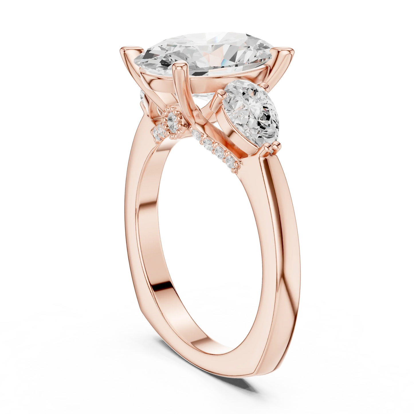 Back view of rose gold oval three stone ring featuring pear side stones and polished band