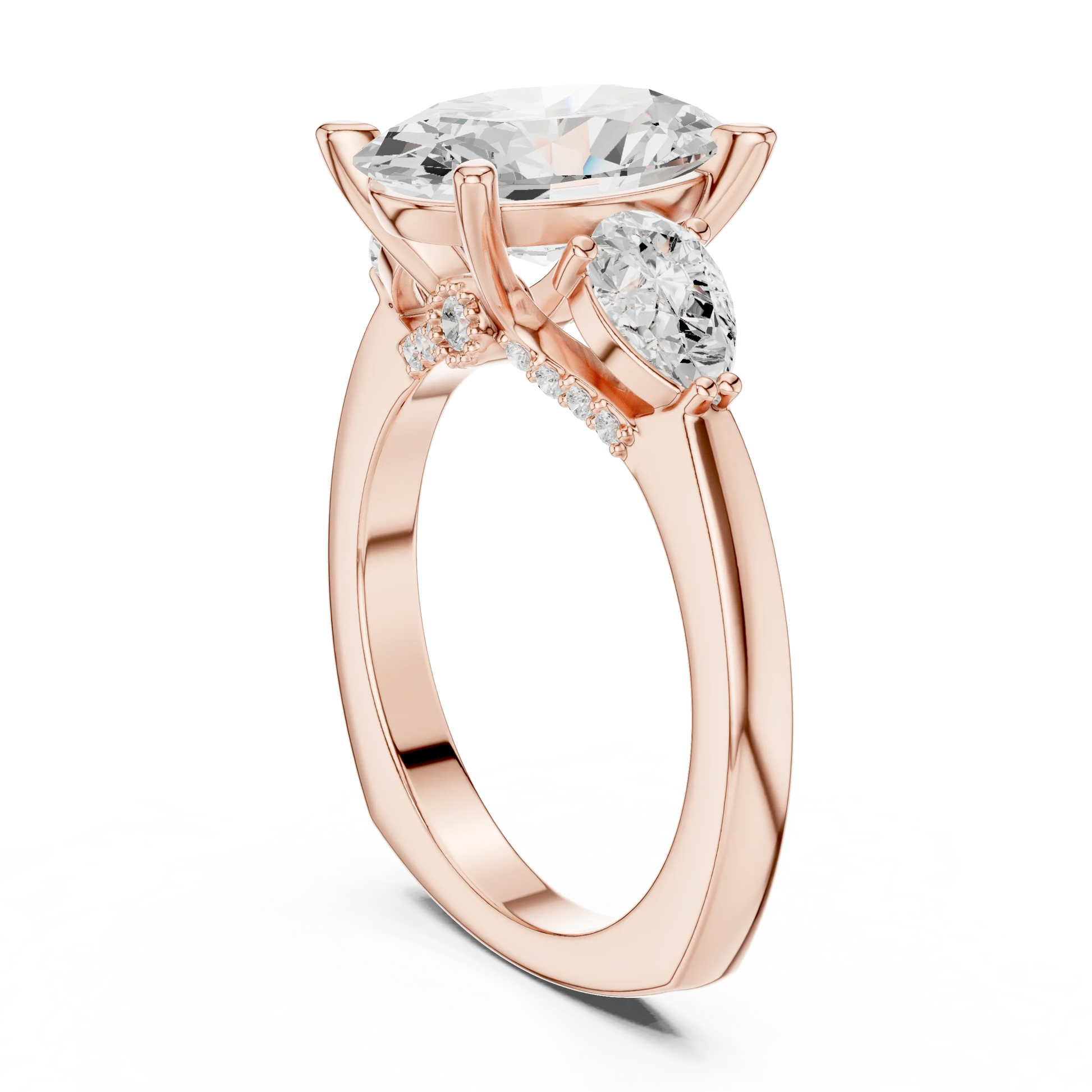 Back view of rose gold oval three stone ring featuring pear side stones and polished band