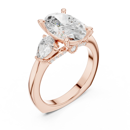 Front view of rose gold oval three stone ring with pear side stones and lab-grown diamonds