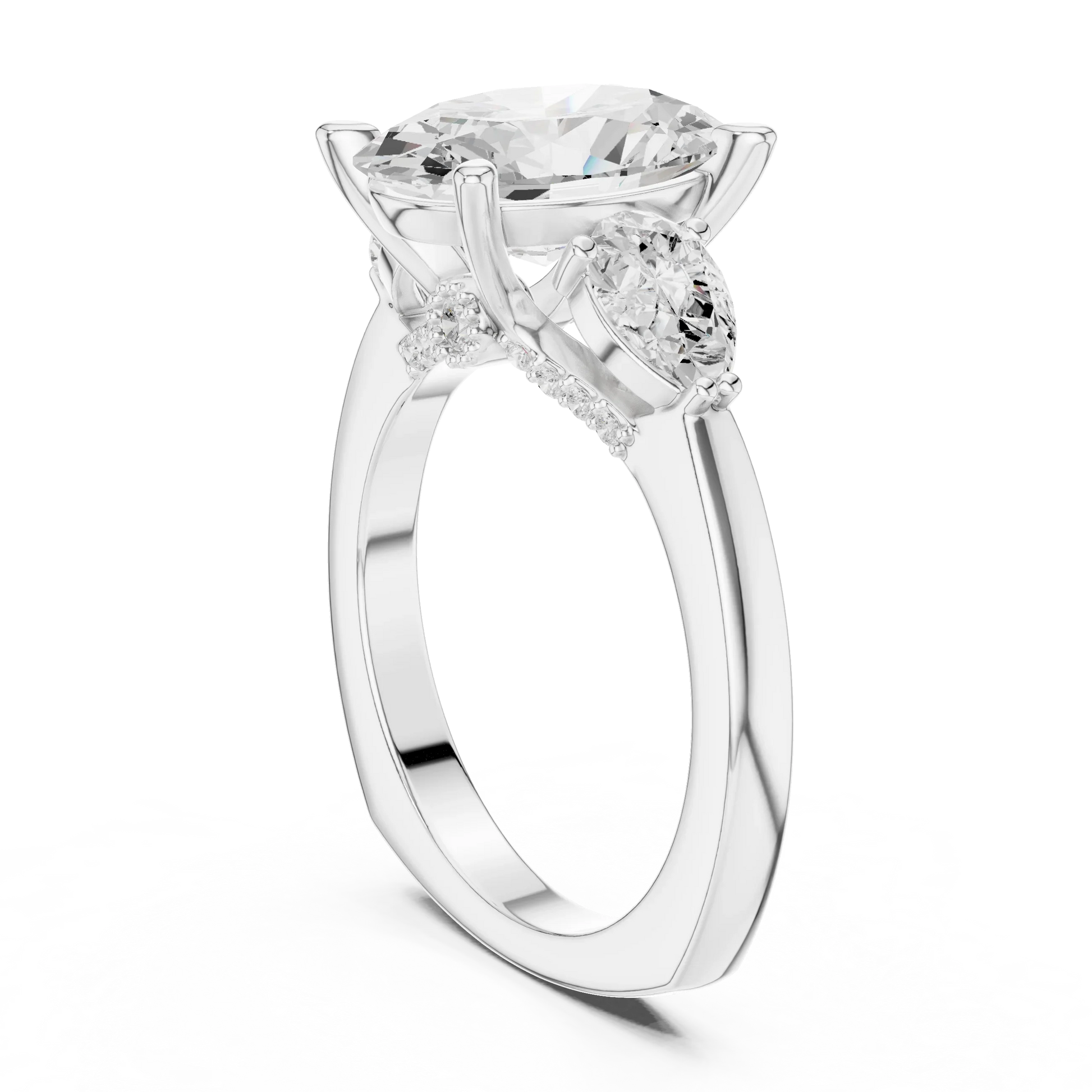 Back view of white gold oval three stone ring featuring pear side stones and polished band