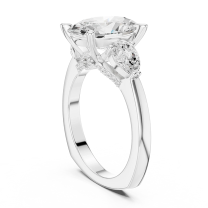 Back view of white gold oval three stone ring featuring pear side stones and polished band