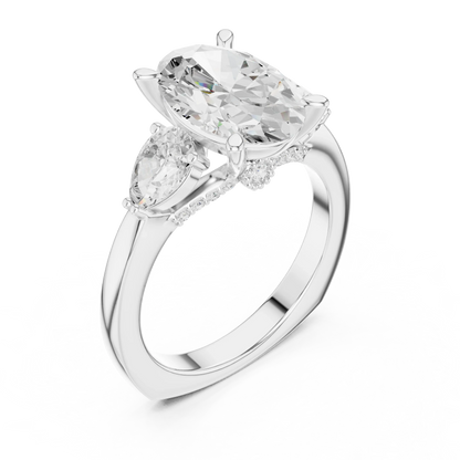 Front view of white gold oval three stone ring with pear side stones and lab-grown diamonds